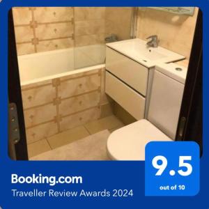 a bathroom with a toilet and a sink and a tub at Page2 Apartament in Târgovişte +15 photos