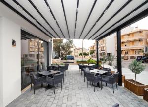 a patio with tables and chairs on a building at Deluxe Apartments & Spa in Ulcinj