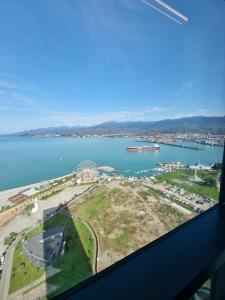 a view of a large body of water from a window at Premium apartment in Porta Batumi Tower in Batumi