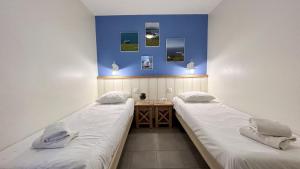 a room with two beds and a desk in it at Argousiers 21 in Fort-Mahon-Plage
