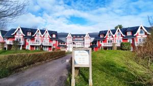 a large red and white house with a sign in front at Argousiers 21 in Fort-Mahon-Plage