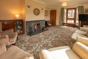 a living room with a fireplace and couches at Beckfoot Chapel Stile - Ambleside in Chapel Stile