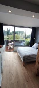 a bedroom with a bed and a large window at Lovely beach in Sainte-Maxime +45 photos