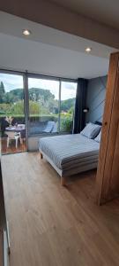 a bedroom with a bed and a large window at Lovely beach in Sainte-Maxime