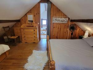 a bedroom with a bed and a dresser with a mirror at Chalet Saint-Michel-de-Chaillol, 3 pièces, 5 personnes - FR-1-393-89 in Saint-Michel-de-Chaillol
