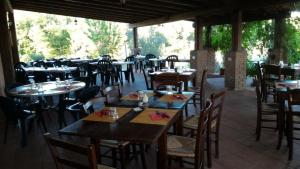 a restaurant with wooden tables and chairs at La Mandriana in Massa Marittima