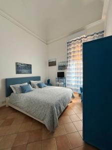 a bedroom with a bed and a large window at Casa Vacanze Penelope in Trapani