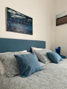 a bed with pillows on it in a bedroom at Casa Vacanze Penelope in Trapani
