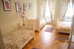 a bedroom with a bed and a desk at Baščaršija Apartments & Rooms in Maribor