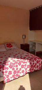a bedroom with a bed with a red and white blanket at rossignol in Chatuzange-le-Goubet