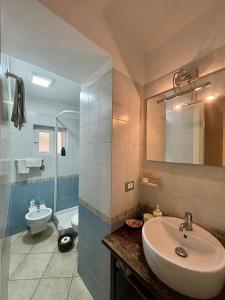 a bathroom with a sink and a toilet at TrentapassidalMare Quinto al mare in Genova