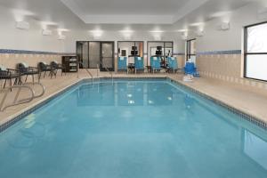 a swimming pool with blue water in a building at TownePlace Suites by Marriott Cheyenne Southwest/Downtown Area in Cheyenne