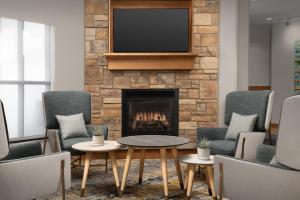 a living room with a fireplace and a tv at TownePlace Suites by Marriott Cheyenne Southwest/Downtown Area in Cheyenne