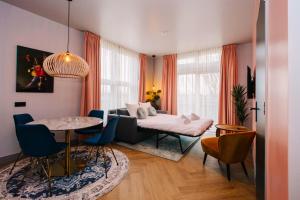a living room with a couch and a table at Hotel Keur in Zandvoort