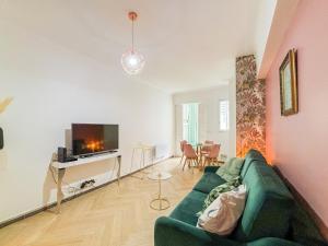 - un salon avec un canapé vert et une télévision dans l'établissement Nice Plage - Wifi, AC, hyper centre, 4 pers, à Nice
