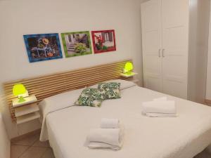 1 dormitorio con 1 cama blanca y 2 almohadas en Villa Gio' Iun R4245, en Sinnai
