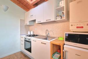 a kitchen with a sink and a stove top oven at Appartamenti Benaco in Peschiera del Garda
