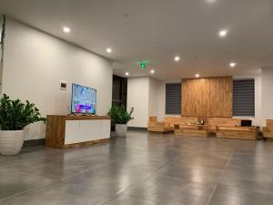 a large lobby with a television and wooden furniture at Mỡ Villa Cao Bằng in Cao Bằng