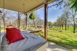 a bed with red pillows on it under a tent at Peaceful Cameron Getaway about 5 Mi to Poteau! 