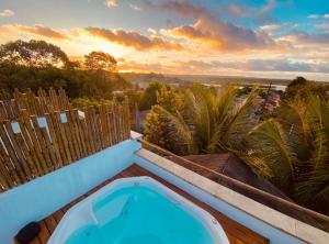 a hot tub on the roof of a house at Nomads Flats in Itacaré