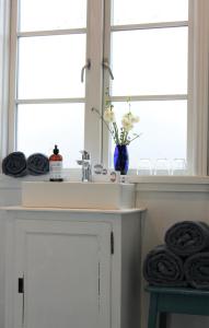 a kitchen counter with a sink and a window at Rosenhøj Bed and Breakfast in Svendborg