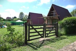 a wooden fence in front of a small house at LA SERAFINA in Chicoana