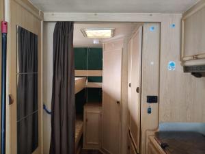 a small room with a door and a closet at Helsinki's Caravan Adventureヅ in Helsinki