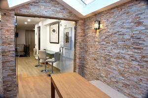 an office with a brick wall and a table and chairs at Family House Cup in Tomar