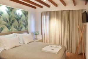 a bedroom with a bed with a large painting on the wall at Family House Cup in Tomar