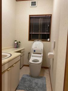 a bathroom with a toilet and a sink and a window at KOTO TEA HOUSE - Vacation STAY 12808 in Kumamoto