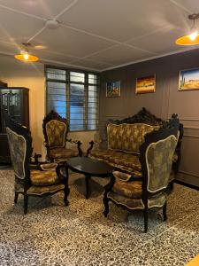 sala de estar con 2 sillas y mesa de centro en Hostal La Casta en Camarones