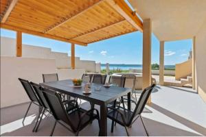 a table and chairs on the patio of a house at HOLIDAY HOME LUANA in Maslenica