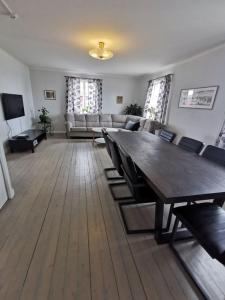 a living room with a large table and a couch at Västervik rum & Stugor in Västervik