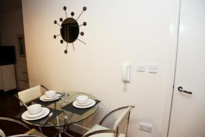 a dining room with a glass table and chairs at AA City Apartments in Newcastle upon Tyne