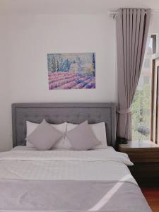 Postel nebo postele na pokoji v ubytování Amia Dalat