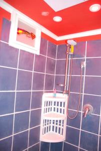 a bathroom with a shower with a blue tiled wall at Comics Factory Airport & City in Catania