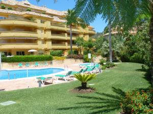 a hotel with a swimming pool and a resort at Greenlife Village Apartment in Marbella