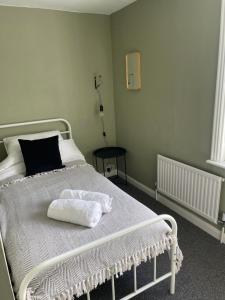 a bedroom with a white bed with a pillow on it at Cozy Town House in Lewes