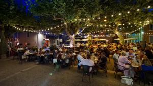 a group of people sitting at tables at an event at Maison d'Hôtes Les Sources in Villedieu +97 photos