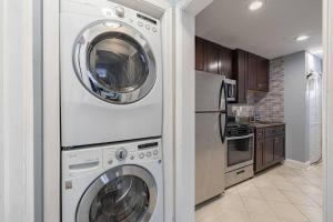 a kitchen with a washer and dryer in a room at Cozy Updated 2BR Apartment in DC in Washington