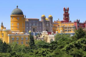 a large building with a clock tower on top of it at Casa Jasmim in Sintra +2 photos