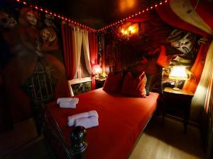 sypialnia z łóżkiem z czerwoną kołdrą w obiekcie Le Cirque Ensorcelé - Le Studio Maudit & Cosy w Belfort +14 zdjęć