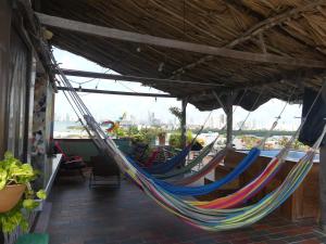 a couple of hammocks hanging from a building at La Terraza de Estella in Cartagena de Indias