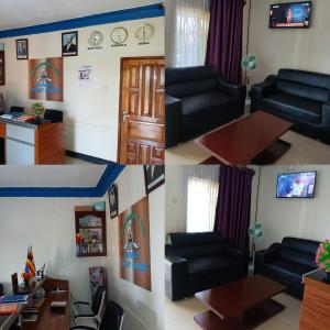 a living room with a black couch and a table at Emmas' Guest House in Kampala