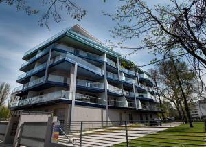 a building with balconies on the side of it at Mistral Residence 408 in Balatonföldvár