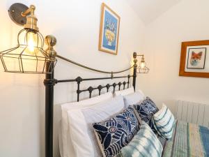 a lamp and pillows on a bed in a room at The Grain Store in Norwich