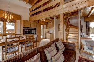 a living room with a couch and a dining room at Chalet Coeur in La Tzoumaz +30 photos