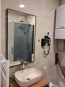 a bathroom with a sink and a shower at Apartman Čuić in Vinkovci