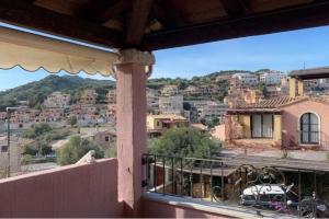 a balcony with a view of a city at Villa a 2 piani vicino al mare in Villasimius