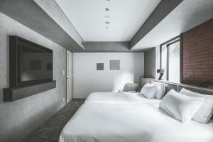 SAPPORO STREAM HOTEL客房内的一张或多张床位